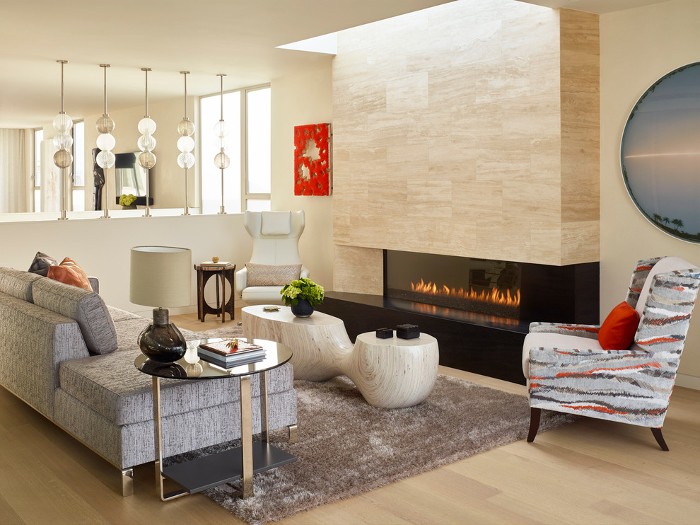 Living room - contemporary light wood floor living room idea in Los Angeles with beige walls and a ribbon fireplace