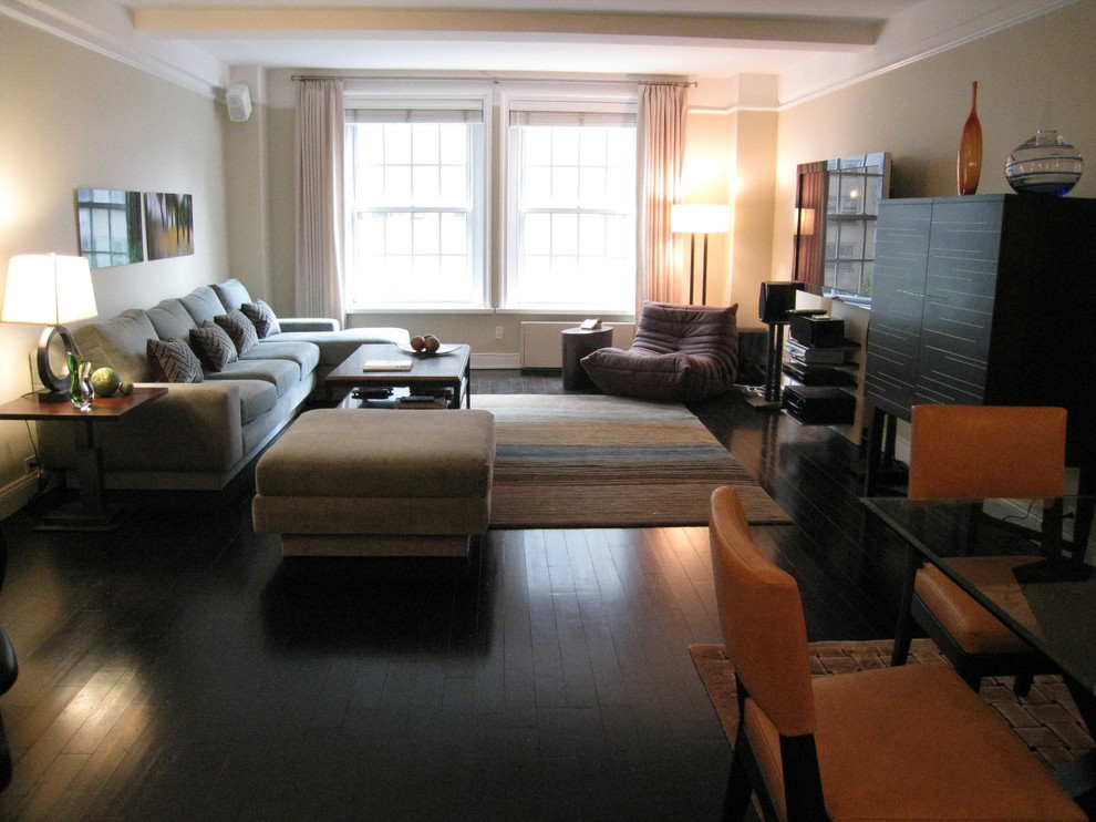 Ejemplo de salón abierto contemporáneo de tamaño medio con paredes beige, suelo de madera oscura y televisor colgado en la pared