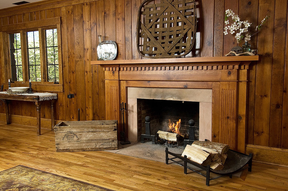 Living room - traditional medium tone wood floor living room idea in Other with a standard fireplace