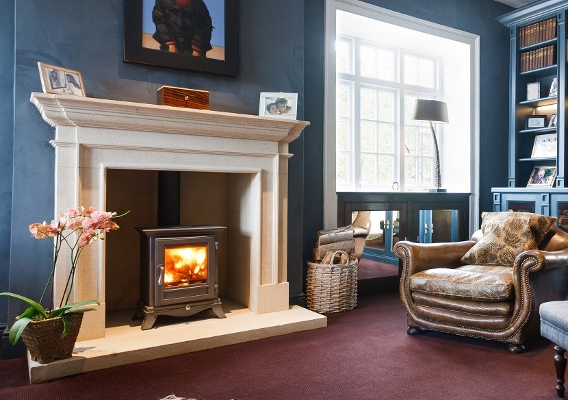 Photo of a classic living room in Other with a wood burning stove and a stone fireplace surround.