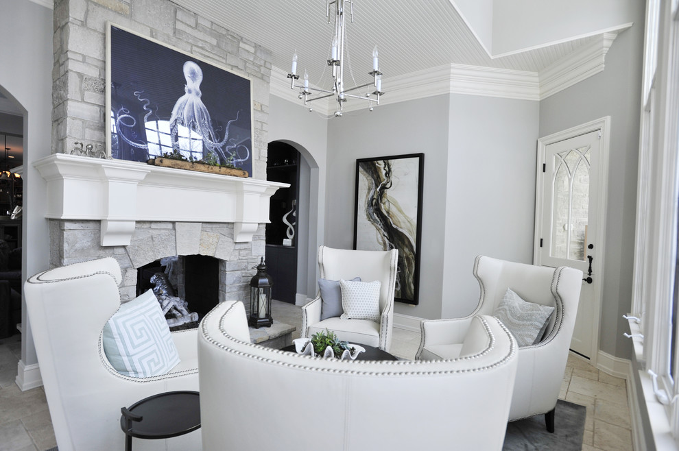 Идея дизайна: парадная, изолированная гостиная комната среднего размера в современном стиле с серыми стенами, полом из травертина, двусторонним камином, фасадом камина из камня и бежевым полом без телевизора