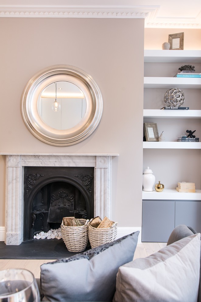 Example of a small trendy open concept medium tone wood floor and brown floor living room design in London with gray walls, a wood stove, a stone fireplace and a wall-mounted tv