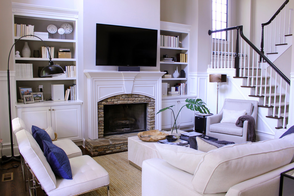 Inspiration for a medium sized classic formal open plan living room in Atlanta with beige walls, dark hardwood flooring, a standard fireplace, a stone fireplace surround, a wall mounted tv and brown floors.