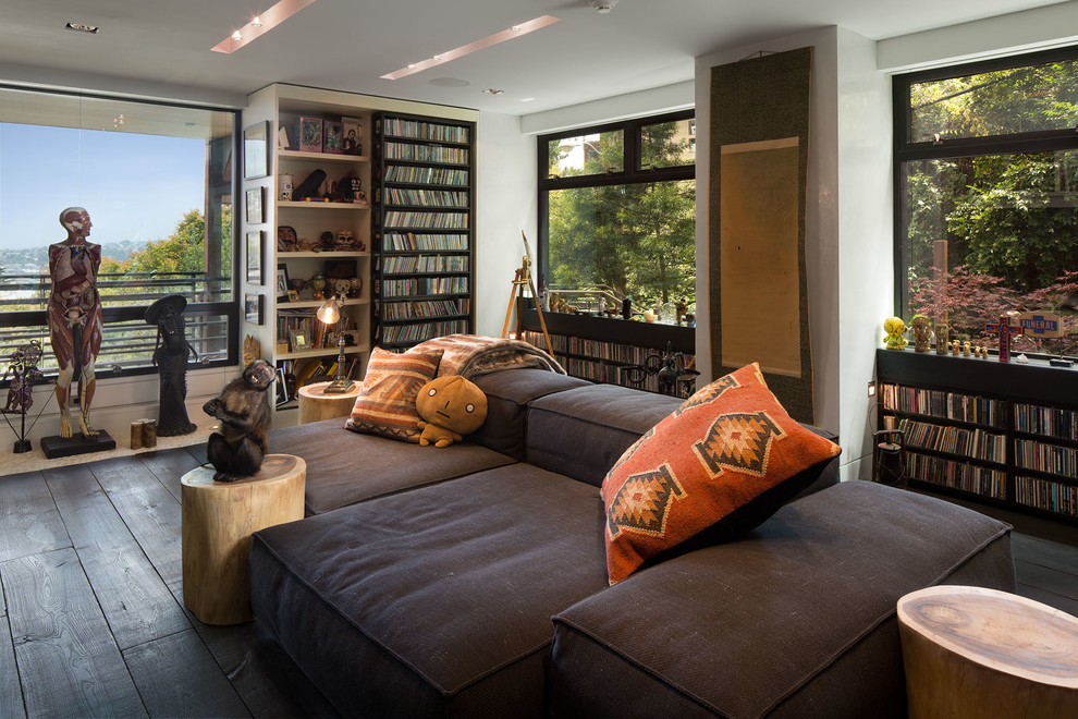Contemporary living room in San Francisco with a reading nook, white walls and dark hardwood flooring.
