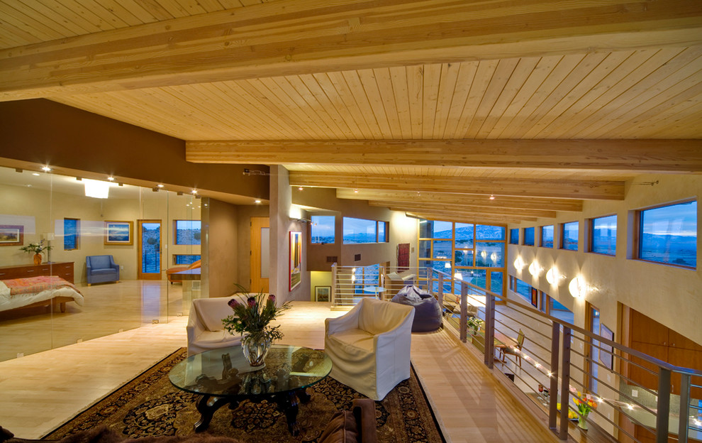 Expansive modern mezzanine living room in Albuquerque with brown walls, light hardwood flooring and no fireplace.