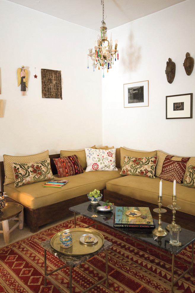 Example of a tuscan living room design in New York with white walls