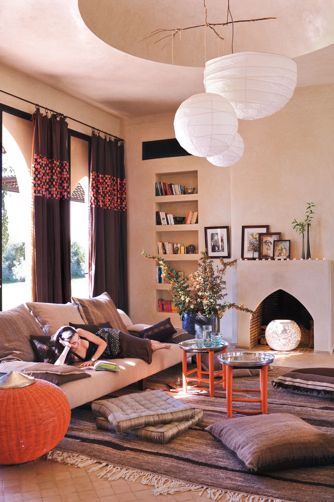 Tuscan living room photo in New York with beige walls and a standard fireplace