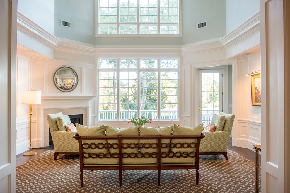 Inspiration for a mid-sized timeless formal and open concept medium tone wood floor and brown floor living room remodel in Charleston with white walls, a corner fireplace, a stone fireplace and no tv