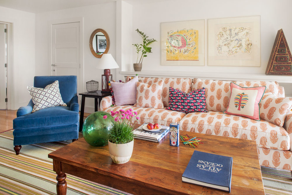 Large coastal open plan living room in Boston with white walls, medium hardwood flooring and a standard fireplace.