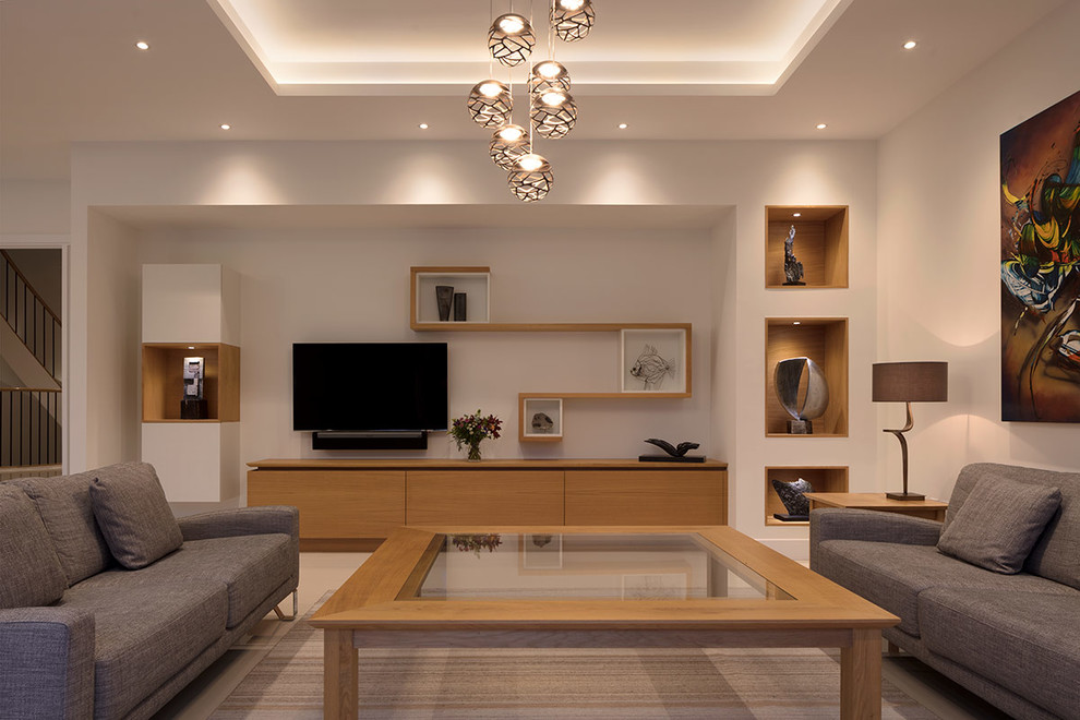 Photo of a large contemporary open plan living room in London with beige walls and a wall mounted tv.