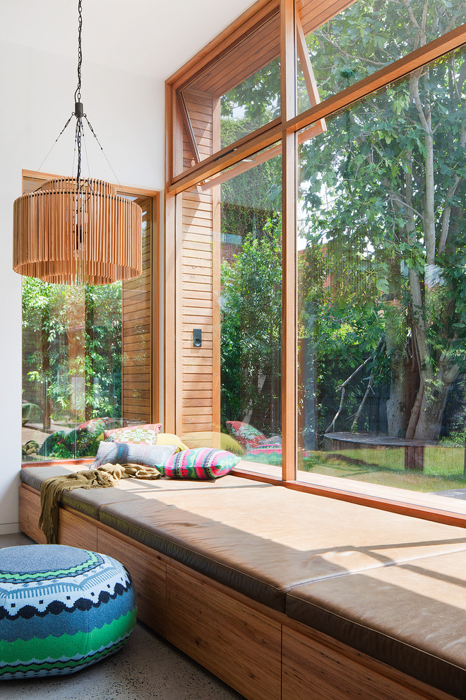 Mid-sized trendy enclosed concrete floor living room photo in Melbourne