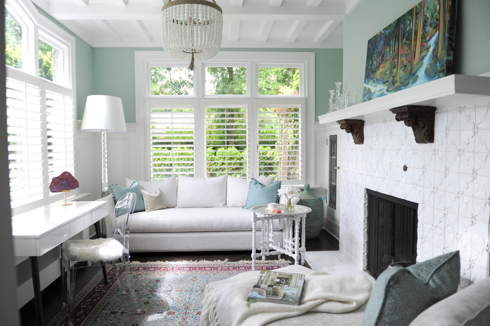 Inspiration for a medium sized classic enclosed living room in Vancouver with green walls, medium hardwood flooring, a standard fireplace, a tiled fireplace surround and no tv.