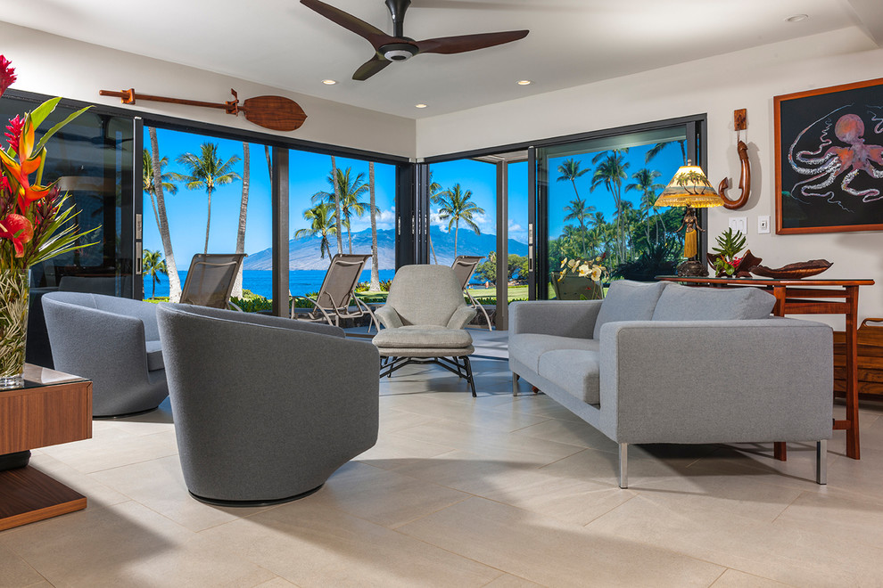 Example of a mid-sized trendy open concept porcelain tile and beige floor living room design in Hawaii with gray walls