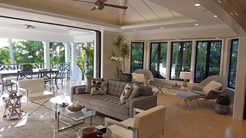 Foto di un soggiorno tropicale di medie dimensioni e aperto con pareti beige, pavimento in gres porcellanato, nessun camino e parete attrezzata