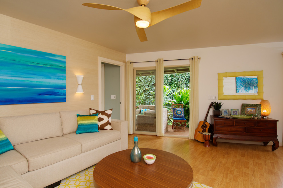 Living room - tropical medium tone wood floor living room idea in Los Angeles with beige walls