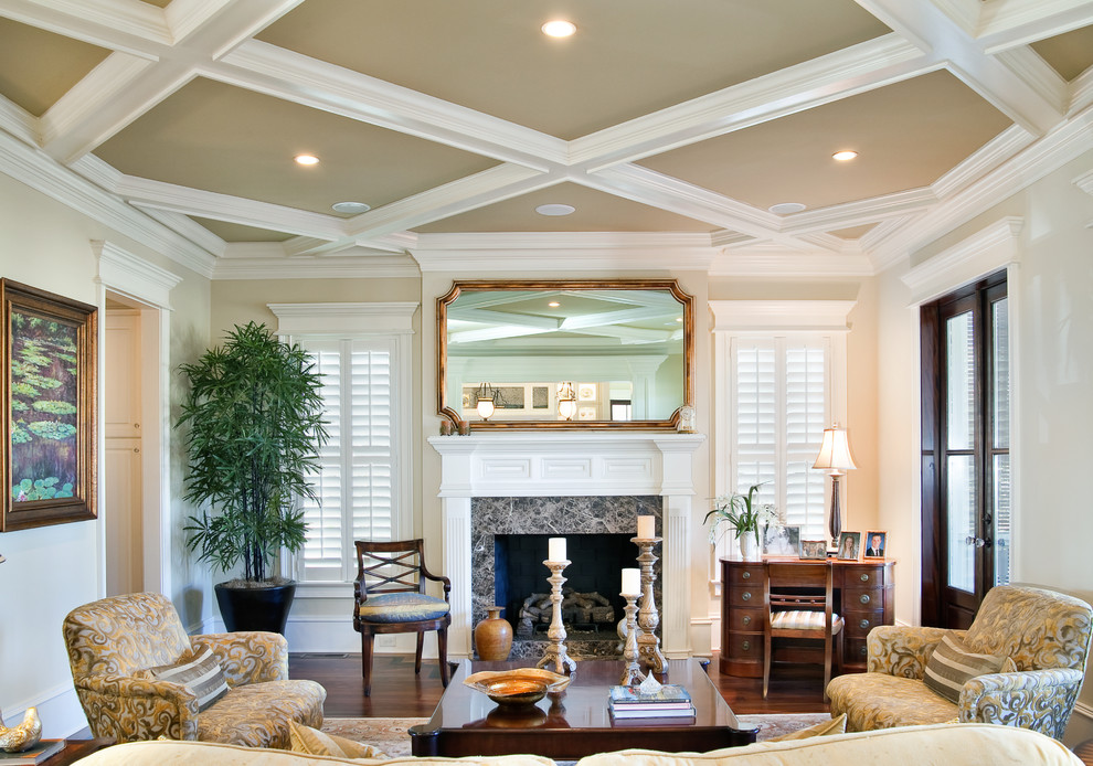 Inspiration for a traditional enclosed living room in Charleston with beige walls and a standard fireplace.