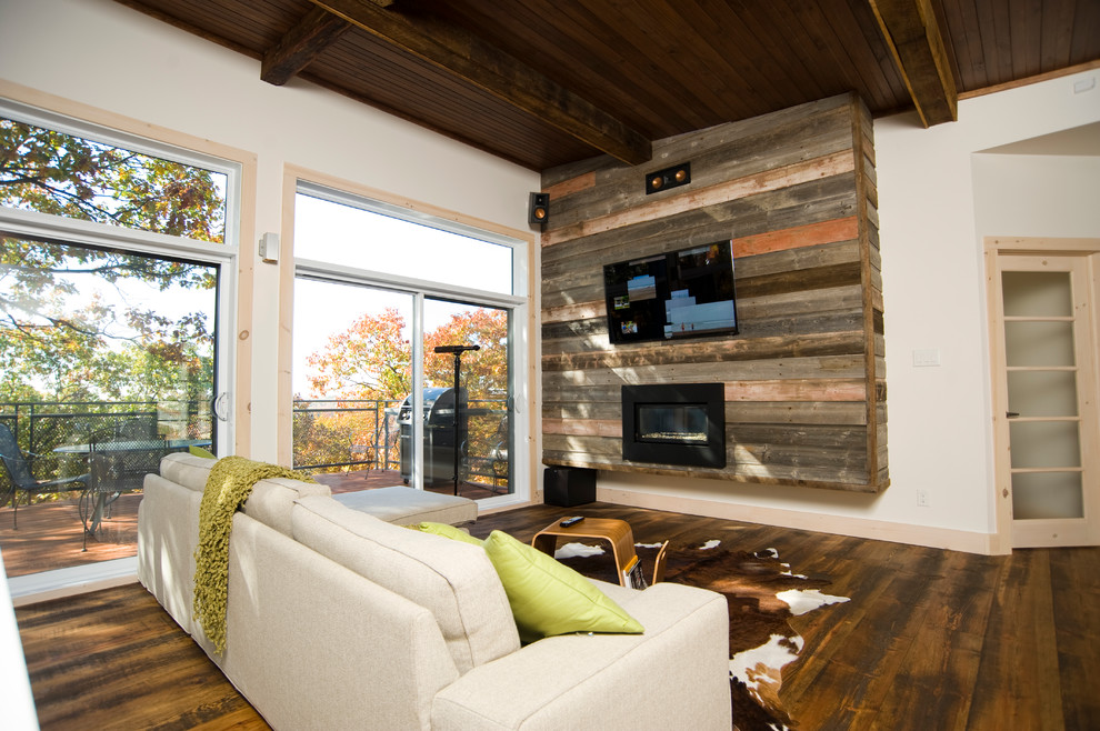 Contemporary living room feature wall in Montreal with a ribbon fireplace and a wall mounted tv.