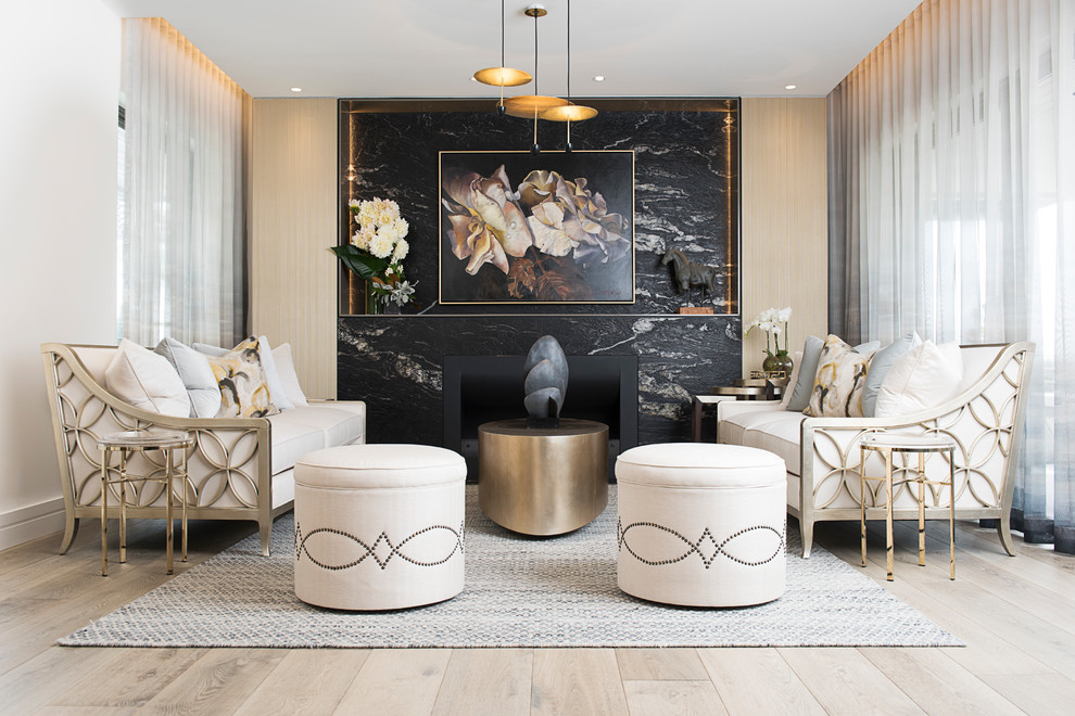 Classic formal and cream and black enclosed living room feature wall in Sydney with white walls, light hardwood flooring, a standard fireplace, a stone fireplace surround and beige floors.