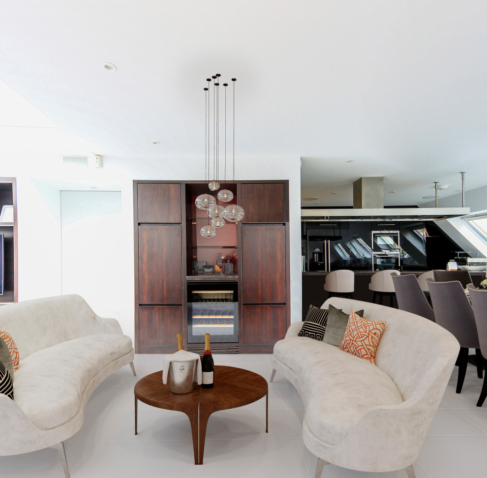 Photo of a medium sized contemporary open plan living room in London with a home bar, white walls and grey floors.