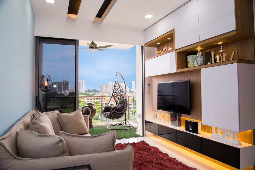 Example of a small trendy living room design in Singapore with a media wall