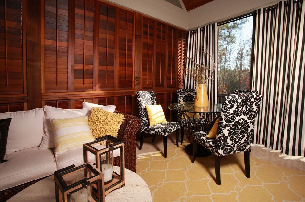 Exemple d'un salon mansardé ou avec mezzanine tendance de taille moyenne avec une salle de réception, un mur vert, un sol en bois brun, une cheminée standard, un manteau de cheminée en pierre et aucun téléviseur.