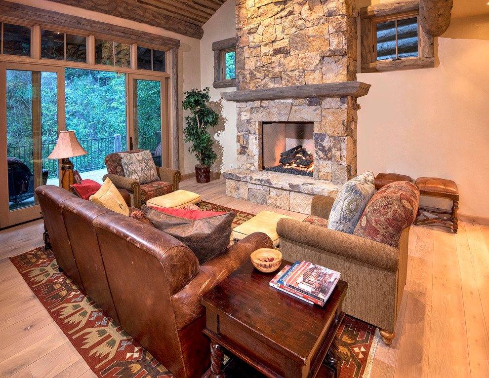 Photo of a rustic living room in Denver with beige walls, light hardwood flooring, a standard fireplace and no tv.
