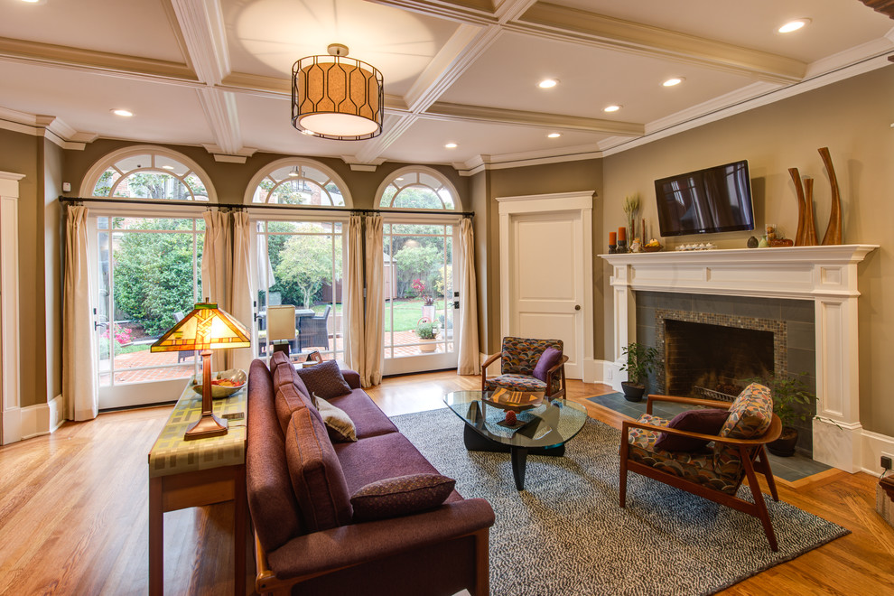 Example of a large arts and crafts formal and open concept medium tone wood floor living room design in San Francisco with beige walls, a standard fireplace, a wood fireplace surround and a wall-mounted tv