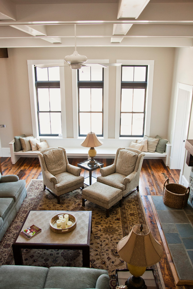 Living room - huge cottage open concept medium tone wood floor and brown floor living room idea in Other with a wall-mounted tv, beige walls, a standard fireplace and a stone fireplace