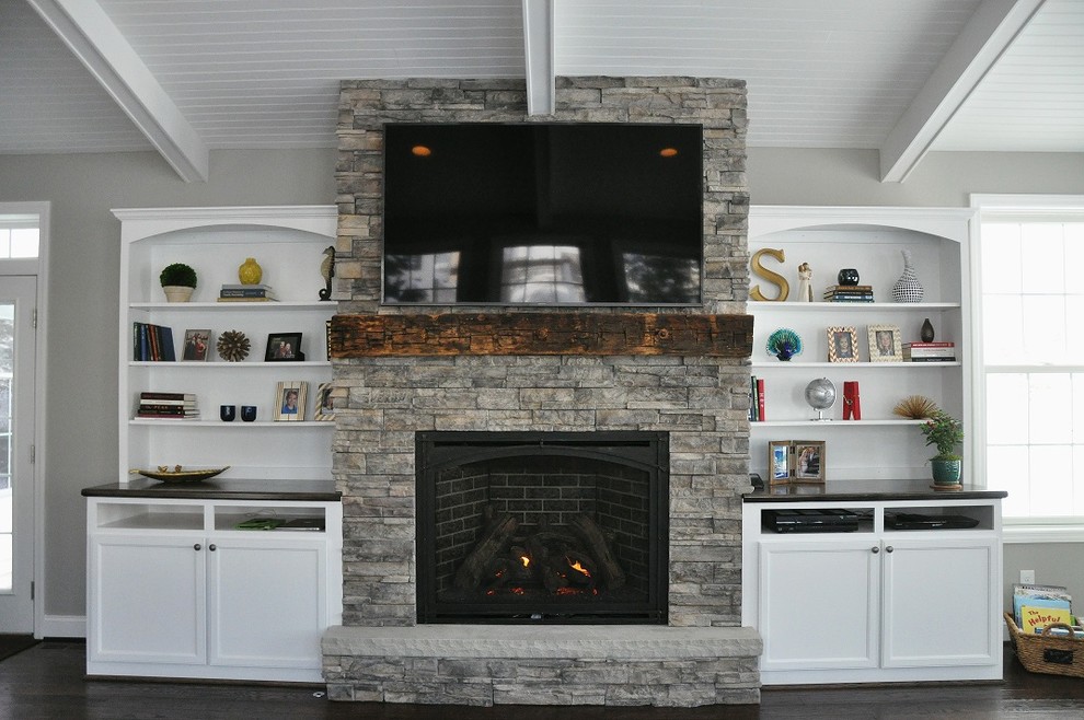 This is an example of a medium sized modern open plan living room in New York with a standard fireplace, a stone fireplace surround and a wall mounted tv.