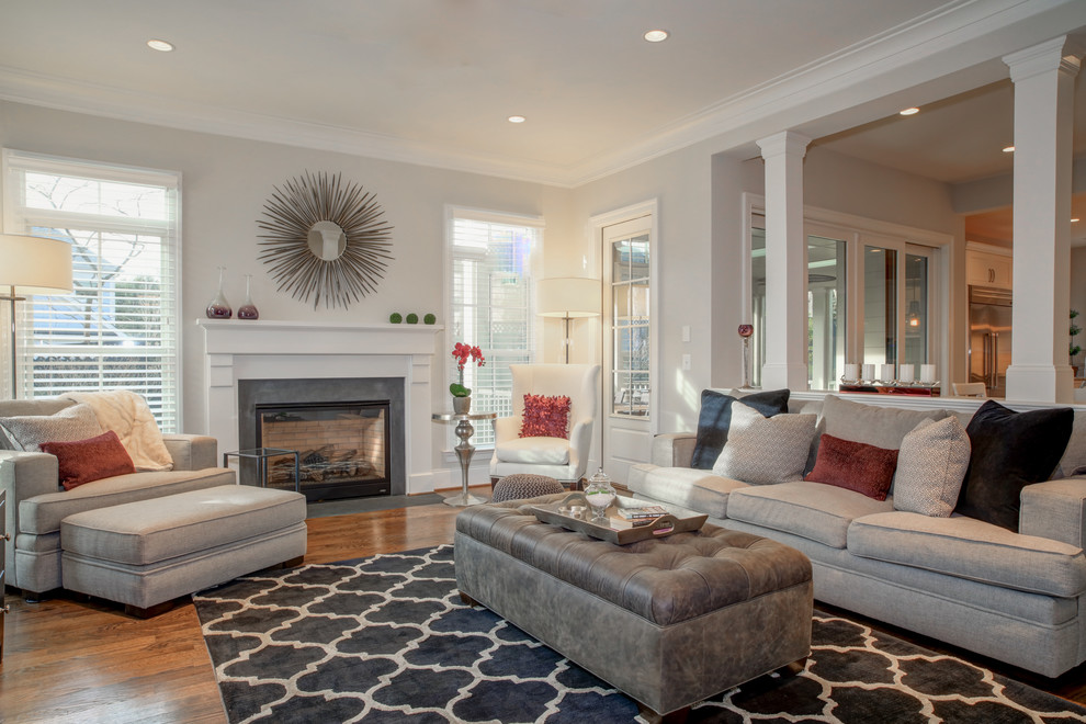 Inspiration for a large classic formal enclosed living room in DC Metro with grey walls, medium hardwood flooring, a standard fireplace, a concrete fireplace surround and feature lighting.