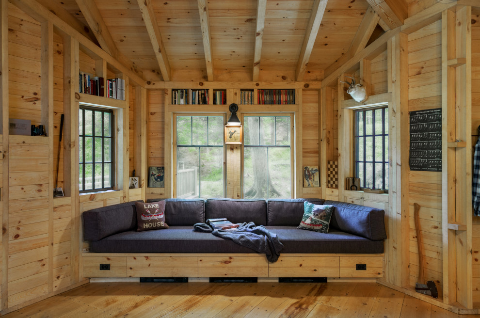 Mountain style medium tone wood floor and brown floor living room photo in Burlington with brown walls