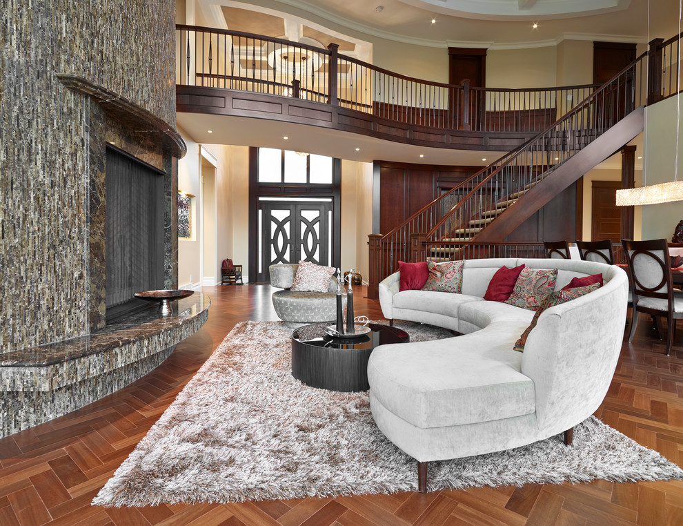 Photo of a traditional open plan living room in Edmonton with medium hardwood flooring, a standard fireplace and a stone fireplace surround.