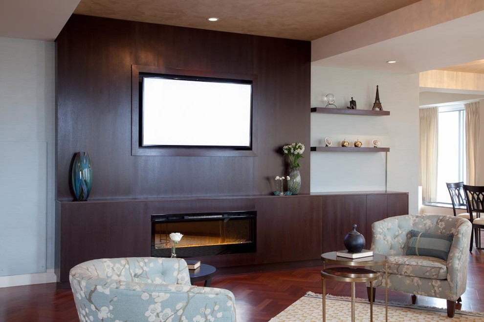 Large trendy formal and open concept dark wood floor living room photo in Boston with a standard fireplace, a wood fireplace surround and a wall-mounted tv