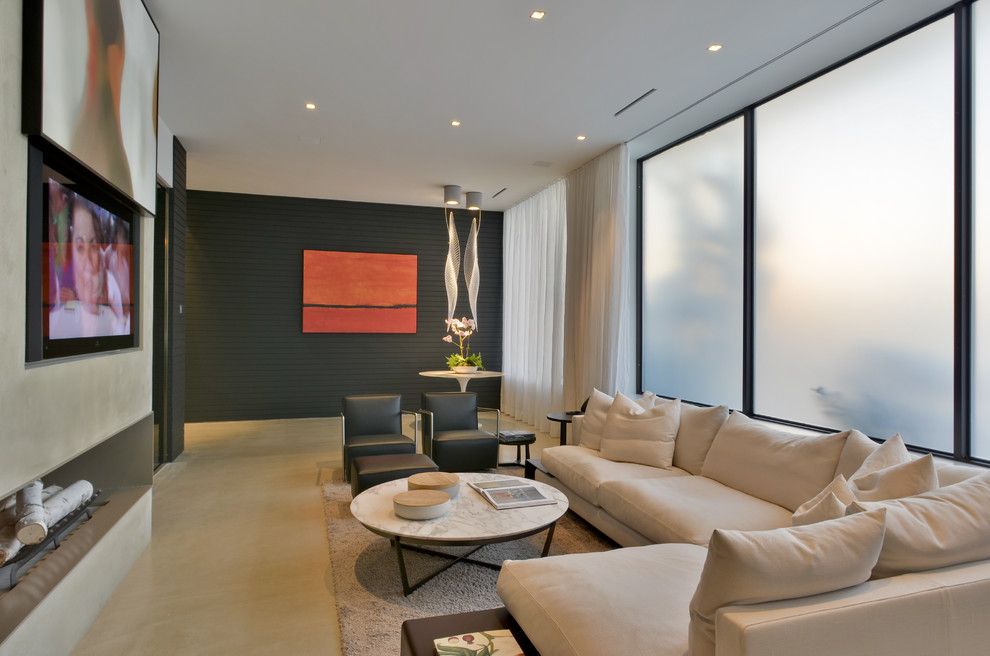 Источник вдохновения для домашнего уюта: большая открытая гостиная комната в современном стиле с черными стенами, двусторонним камином и скрытым телевизором