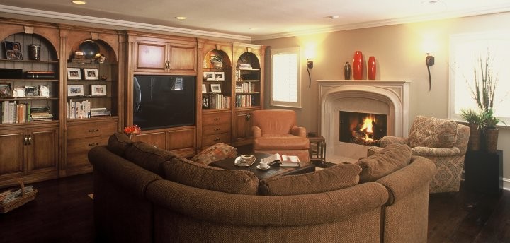 ロサンゼルスにある広いトラディショナルスタイルのおしゃれなLDK (無垢フローリング、両方向型暖炉、木材の暖炉まわり、埋込式メディアウォール) の写真