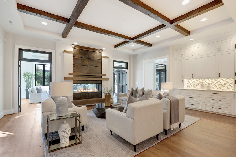 Large trendy open concept medium tone wood floor and brown floor living room photo in Seattle with gray walls, a two-sided fireplace and a metal fireplace