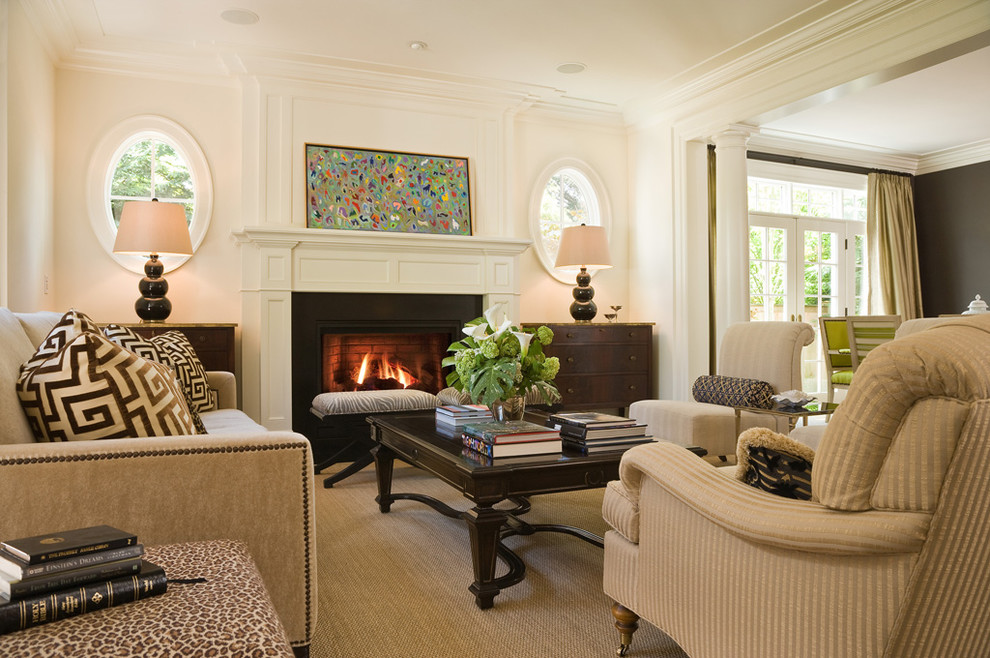 Photo of a traditional formal living room in Seattle with white walls, a standard fireplace, no tv and feature lighting.