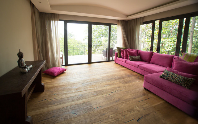 Huge zen open concept medium tone wood floor living room photo in Los Angeles with a music area, beige walls and no tv