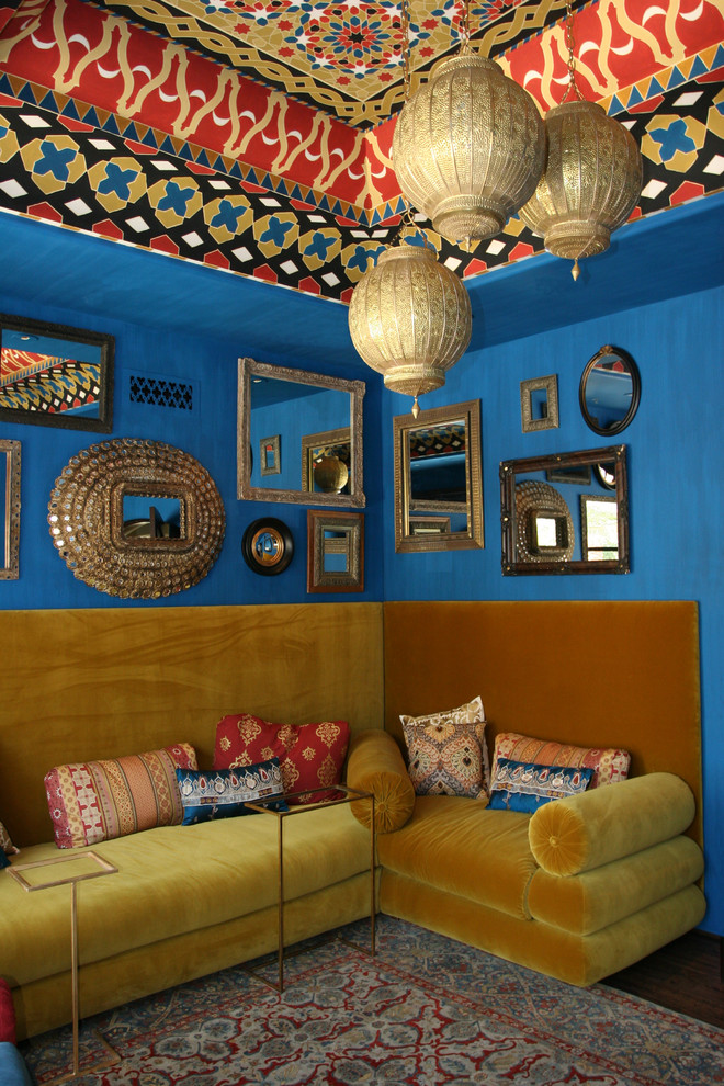 Example of a tuscan living room design in Phoenix with blue walls