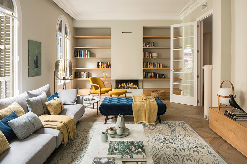 Diseño de biblioteca en casa cerrada mediterránea grande con paredes beige, suelo de madera oscura, pared multimedia, suelo marrón y chimenea lineal