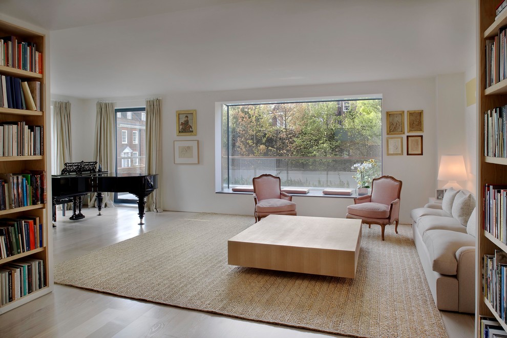 Immagine di un soggiorno design di medie dimensioni e aperto con sala formale, pareti bianche, parquet chiaro e nessuna TV
