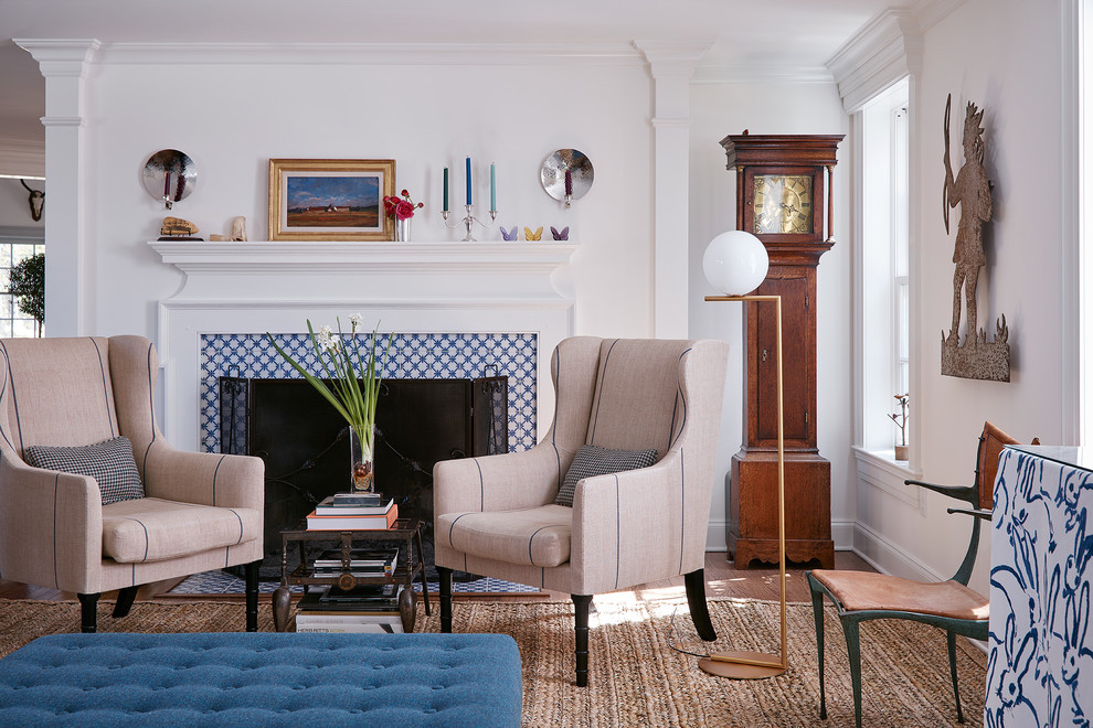 Example of a classic formal dark wood floor and brown floor living room design in New York with white walls, a standard fireplace and a tile fireplace