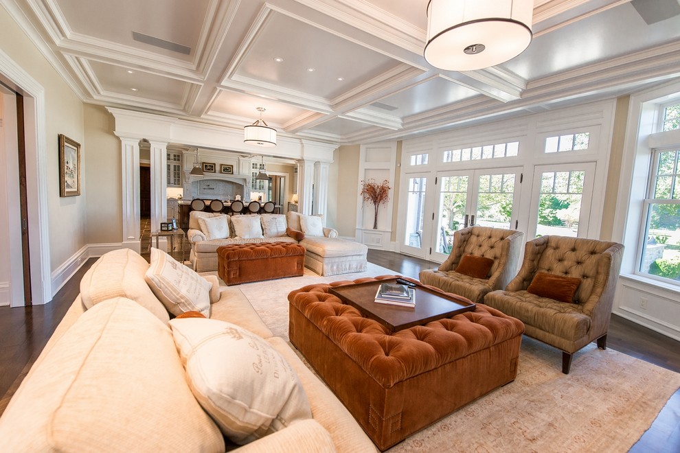 Immagine di un grande soggiorno classico aperto con pareti beige, cornice del camino in pietra, TV a parete e sala formale