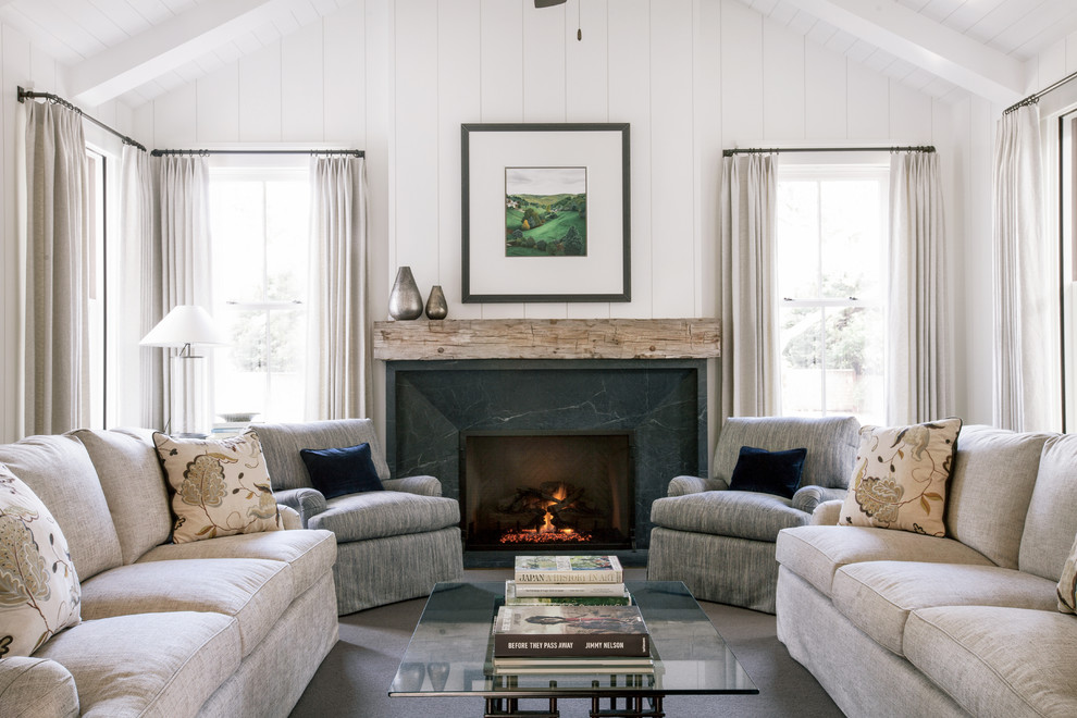 Inspiration for a rural formal living room in San Francisco with white walls, carpet, a standard fireplace, a stone fireplace surround and feature lighting.