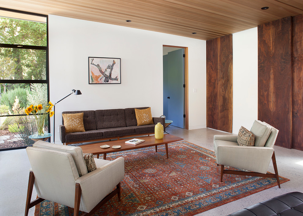 На фото: парадная, изолированная гостиная комната в стиле ретро с белыми стенами и бетонным полом без камина, телевизора с