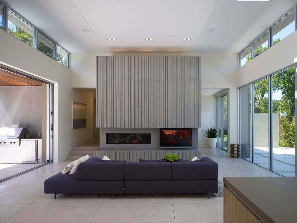 Trendy concrete floor living room photo in San Francisco with a concrete fireplace and a ribbon fireplace
