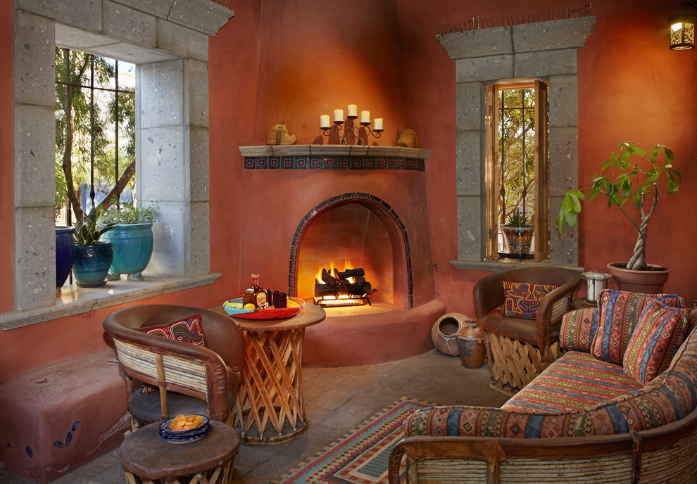 Example of a southwest brown floor living room design in Other with orange walls, a corner fireplace and a tile fireplace