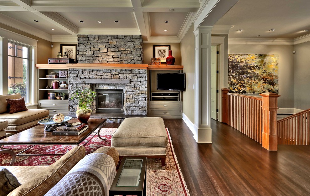 Living room - mid-sized traditional open concept dark wood floor living room idea in Seattle with beige walls, a standard fireplace, a stone fireplace and a wall-mounted tv