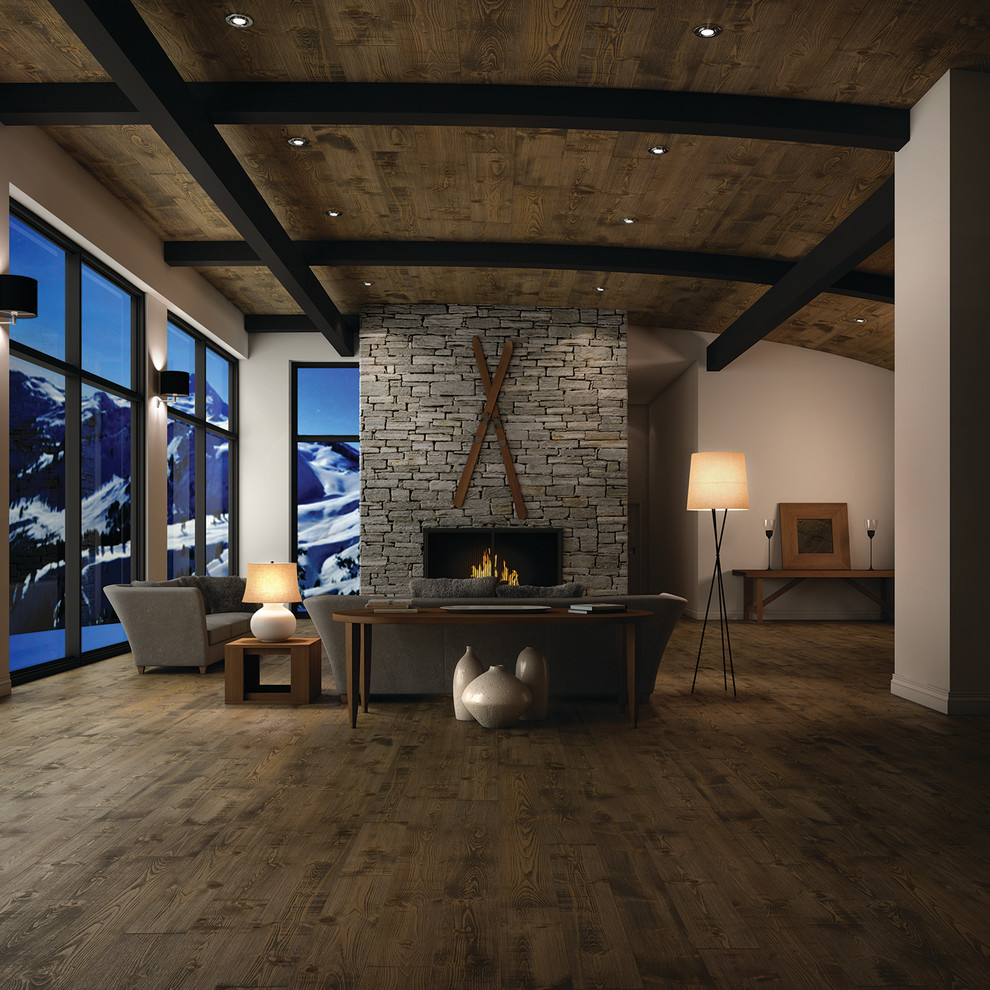 Modelo de salón abierto actual grande sin televisor con suelo de madera oscura, todas las chimeneas y marco de chimenea de ladrillo