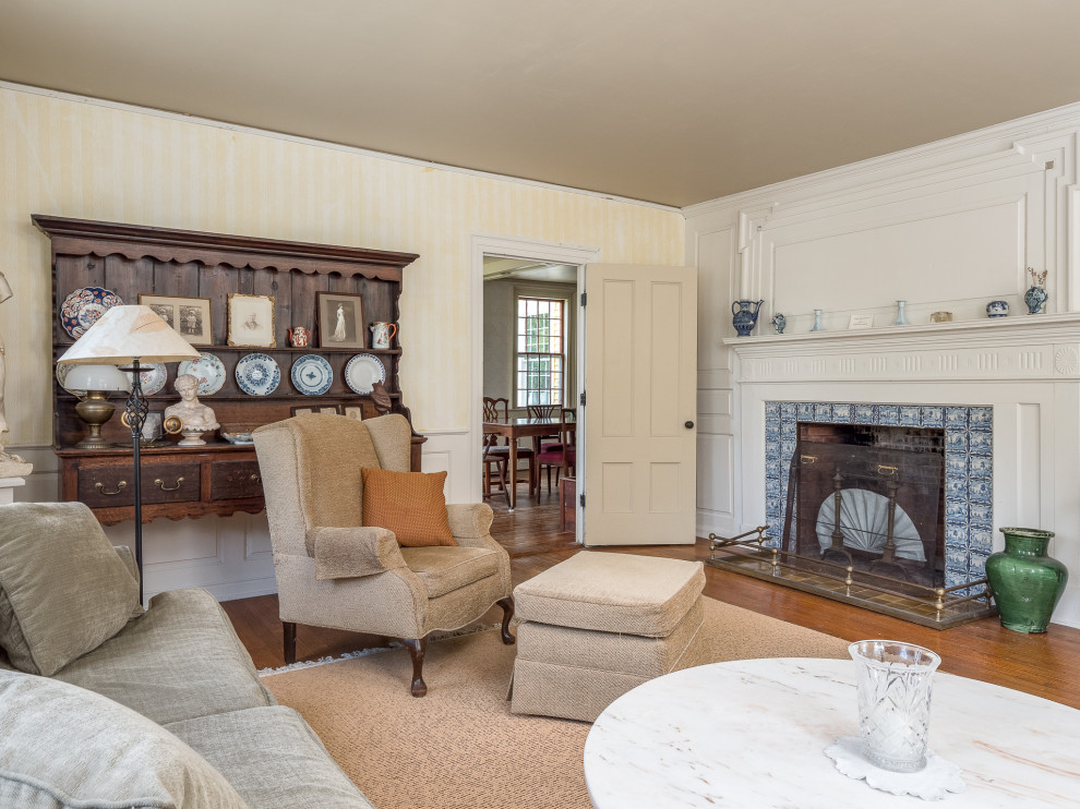 Large cottage formal and enclosed medium tone wood floor living room photo in Portland Maine with beige walls, a standard fireplace and a wood fireplace surround
